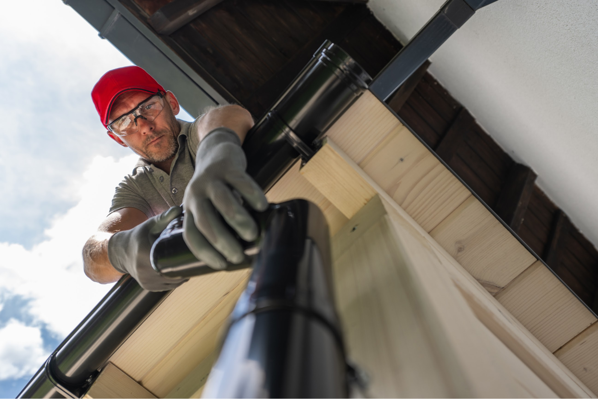A contractor working on a gutter.