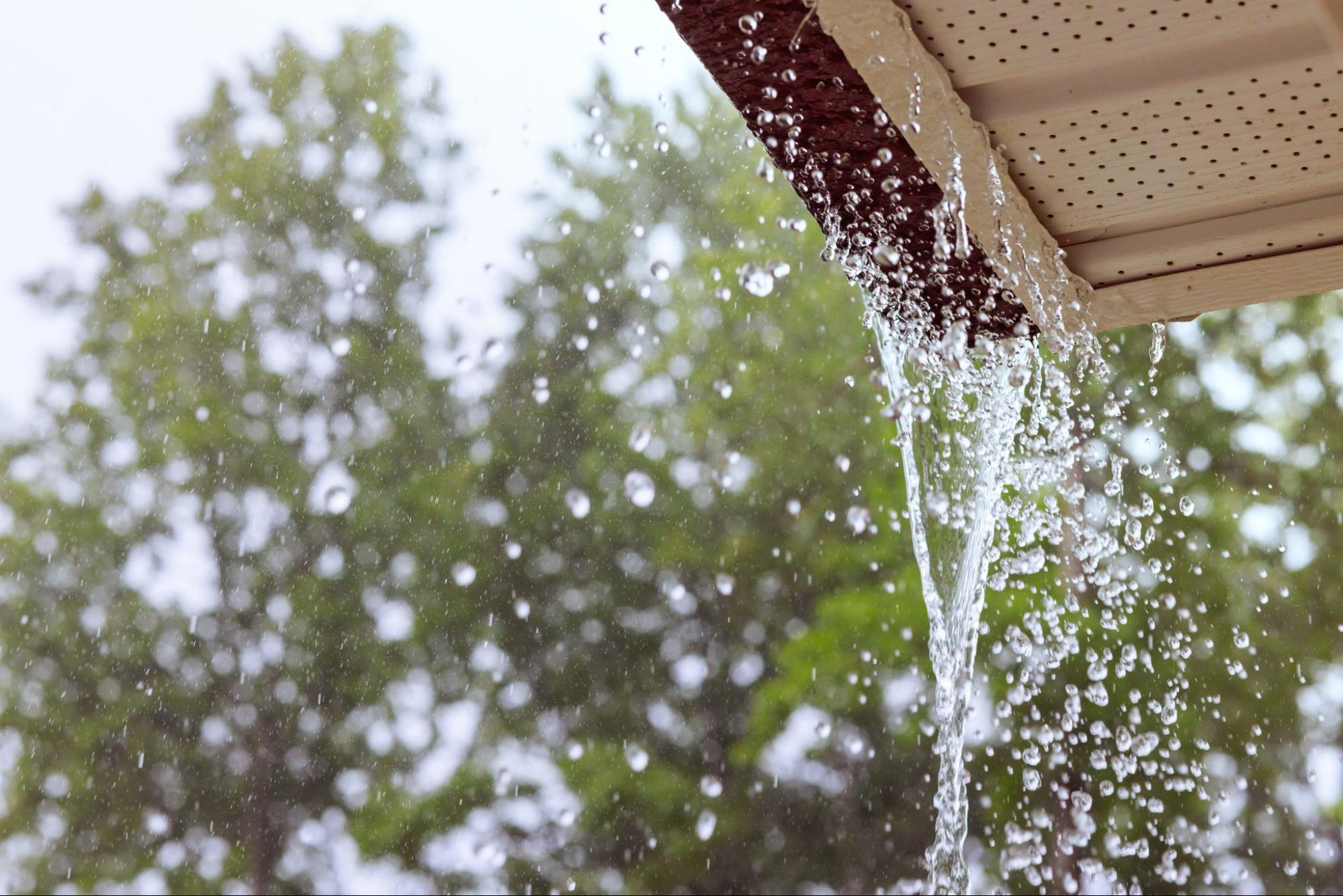 Water overflows from the gutters during heavy rain.