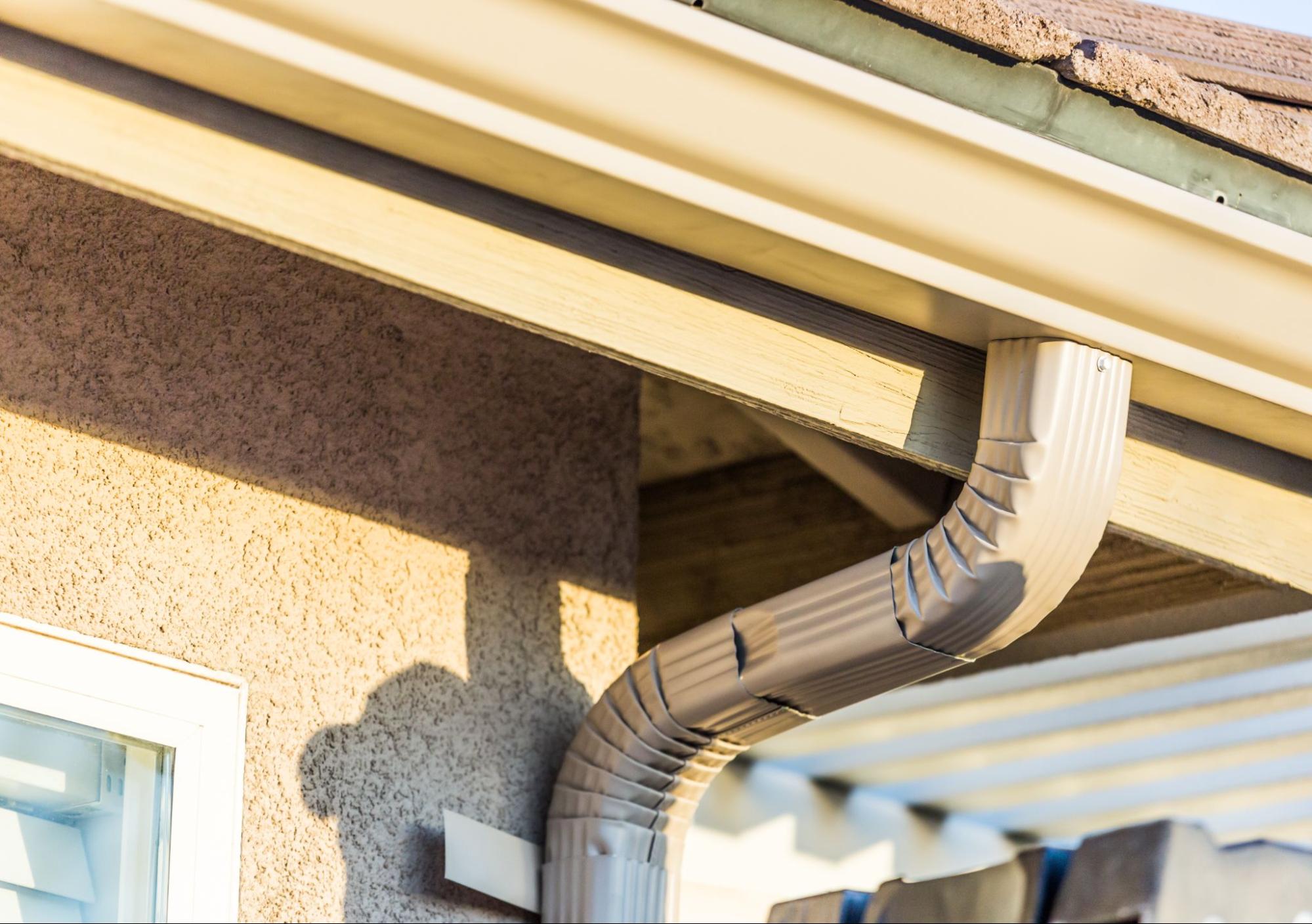 Complete home gutter system with attached downspout for rainwater drainage