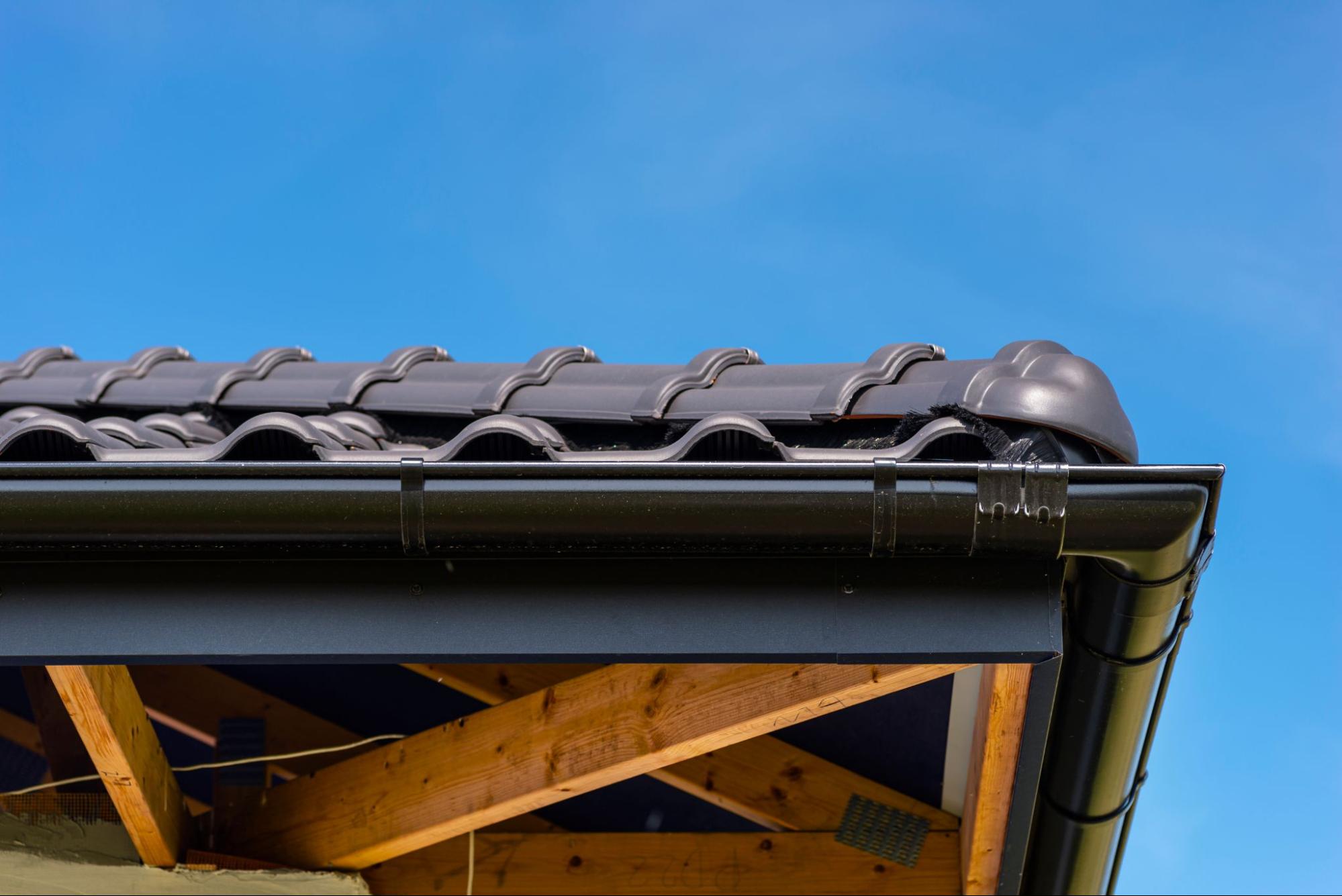 Detailed view of a roof with covered guttering with guards for efficient water flow and reduced clogging
