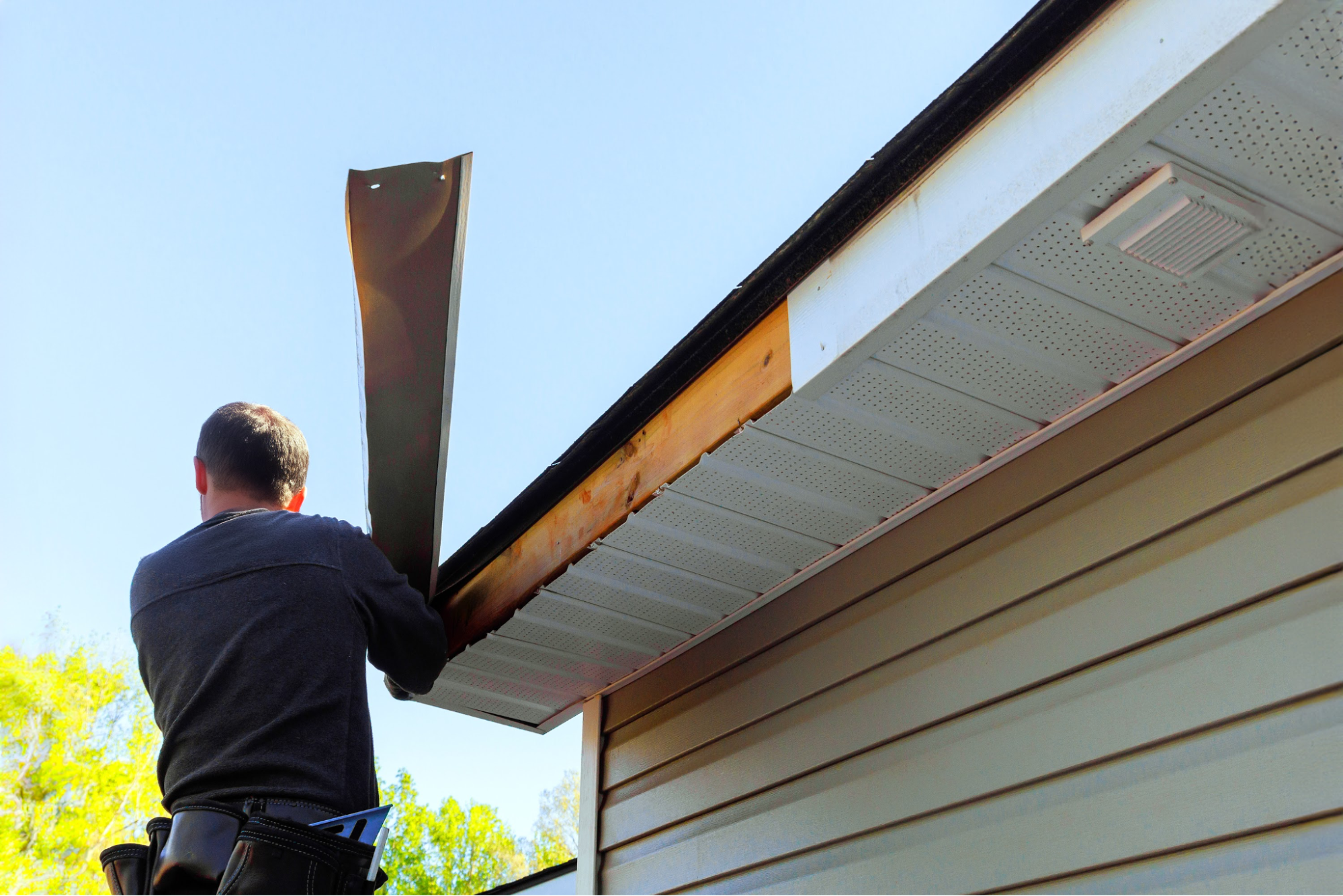 A man making remodels to a fascia.