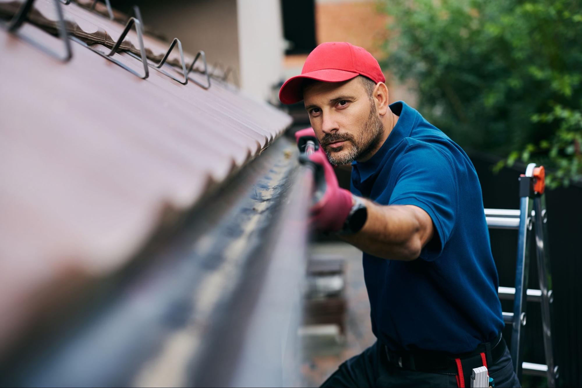 A worker meticulously inspects rain gutters to ensure they are spotless and clear