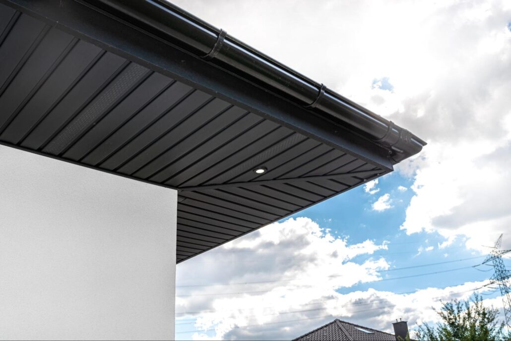 Upward perspective of modern soffit panels and gutter system with seamless installation along the roofline