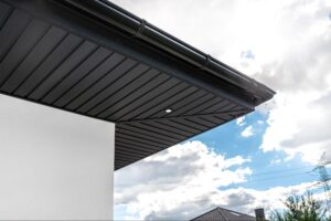 Upward perspective of modern soffit panels and gutter system with seamless installation along the roofline