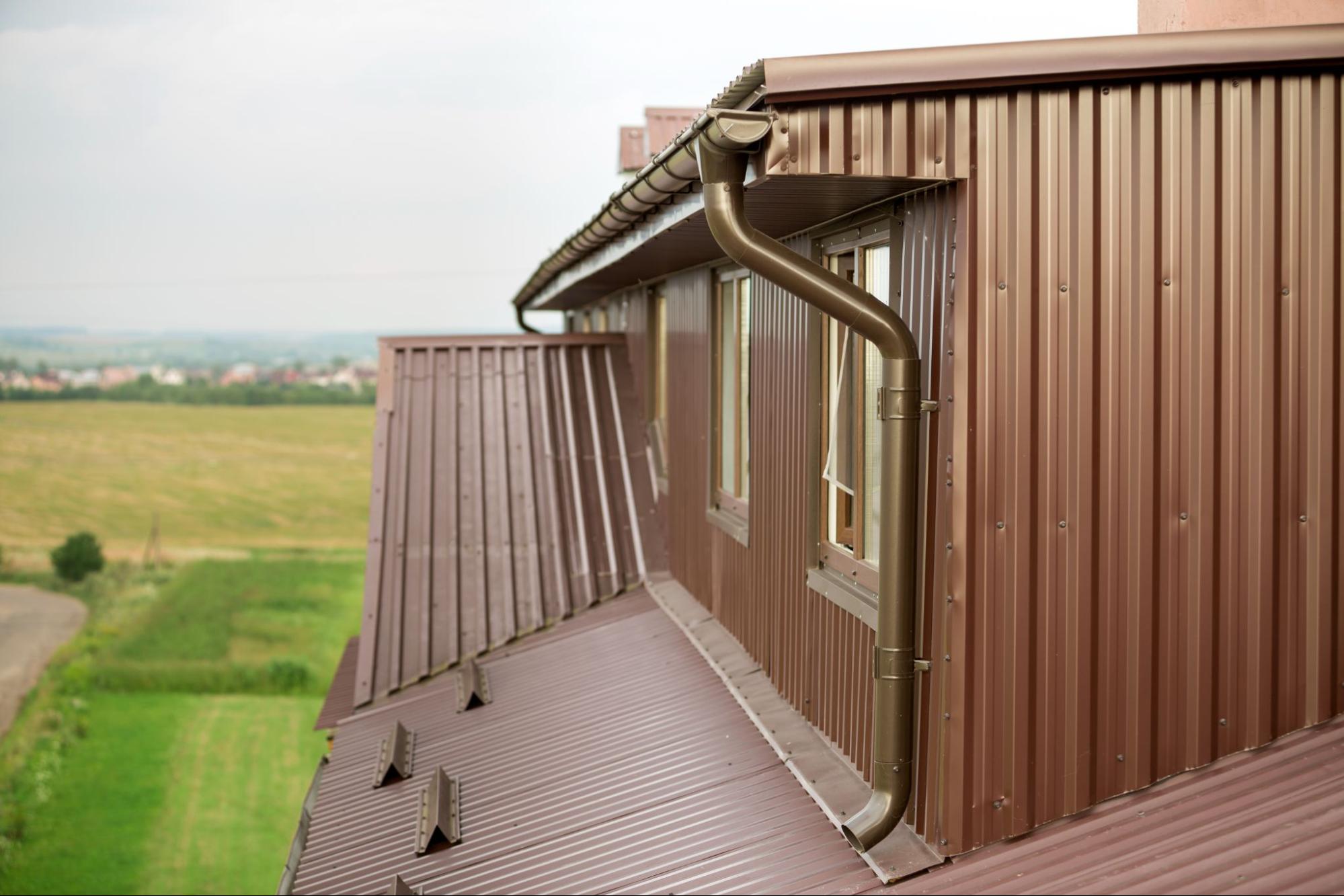 Modern building with professionally installed roof and rain gutter system for effective water drainage and property protection