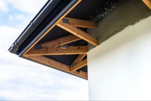View from below of a residential roofline showing fascia and soffit along the roof overhang
